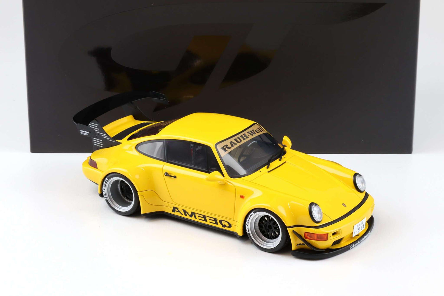 Yellow 1:18 scale Porsche 911 RWB diecast with front three-quarter view and QEEMA decals