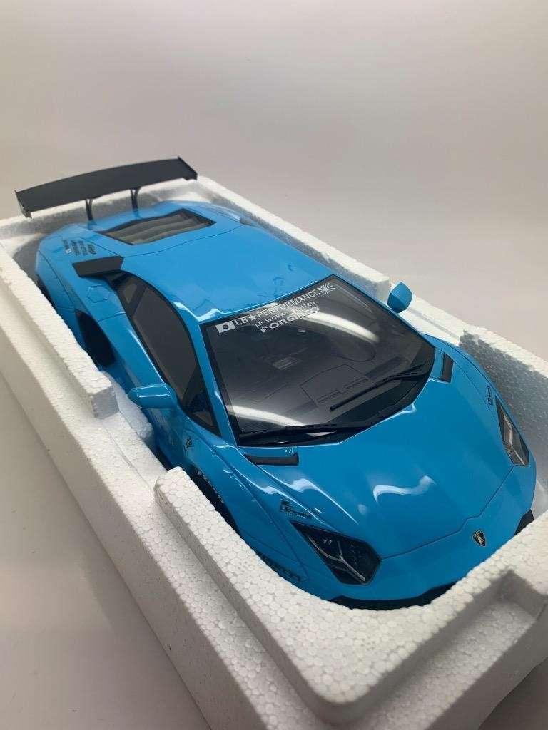 Baby blue die-cast Lamborghini model car in white foam tray, front three-quarter view