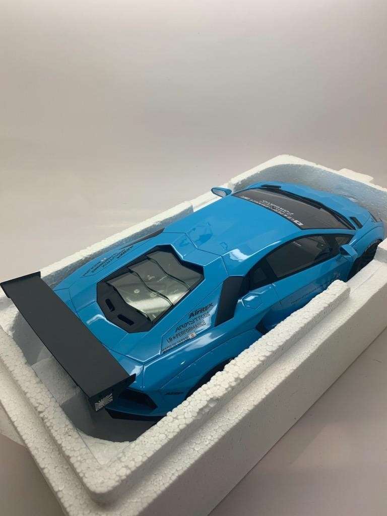 Baby blue die-cast Lamborghini model car in white foam tray, rear three-quarter view