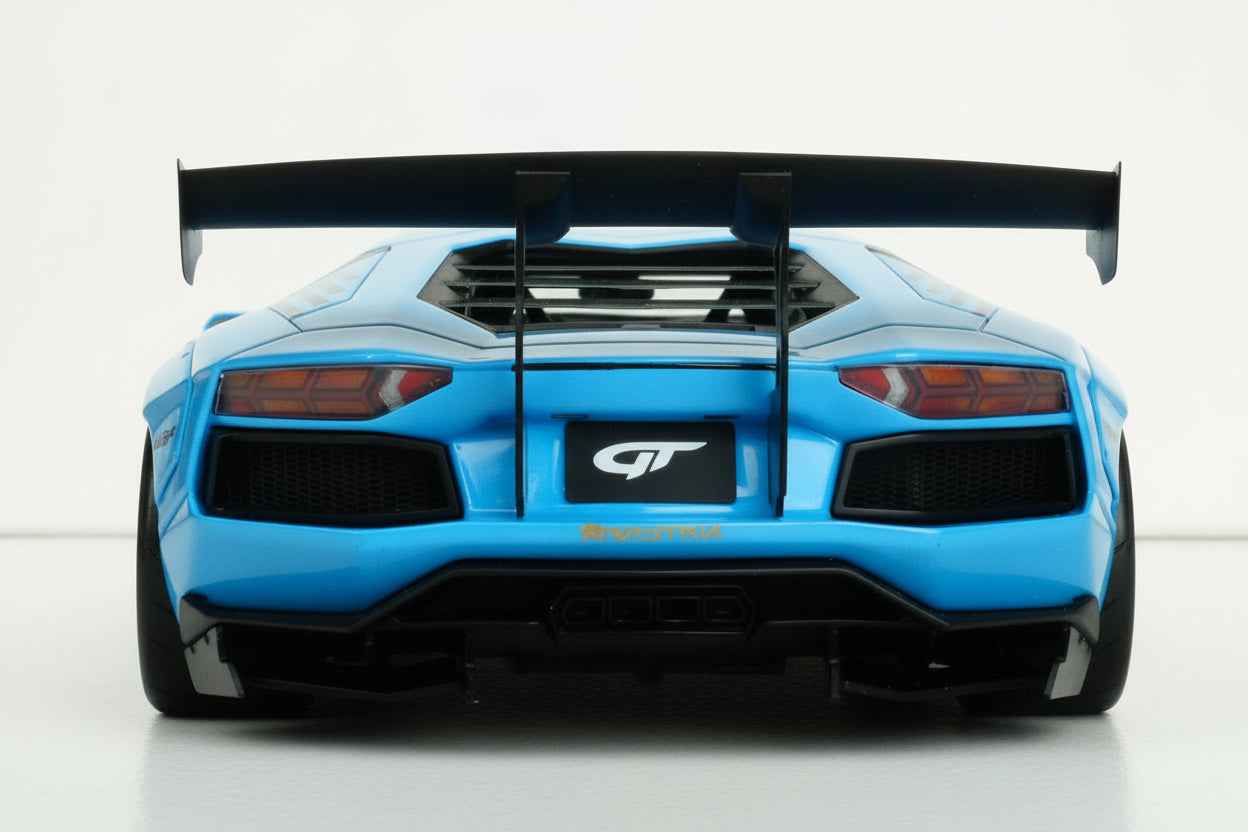Baby blue die-cast sports car model rear view with twin taillights and wing