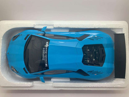 Baby blue die-cast Lamborghini model car in white foam tray, top view with black accents