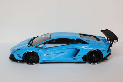 Baby blue die-cast sports car model side profile with black aerodynamic parts