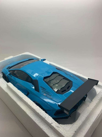 Baby blue die-cast Lamborghini model car in white foam tray, side view with rear spoiler