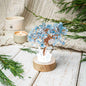 Aquamarine blue crystal tree lamp on round wood base with white crystal accents