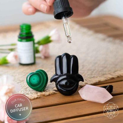 Black hamsa car aromatherapy crystal diffuser with green heart stone, rose quartz, and dropper oil