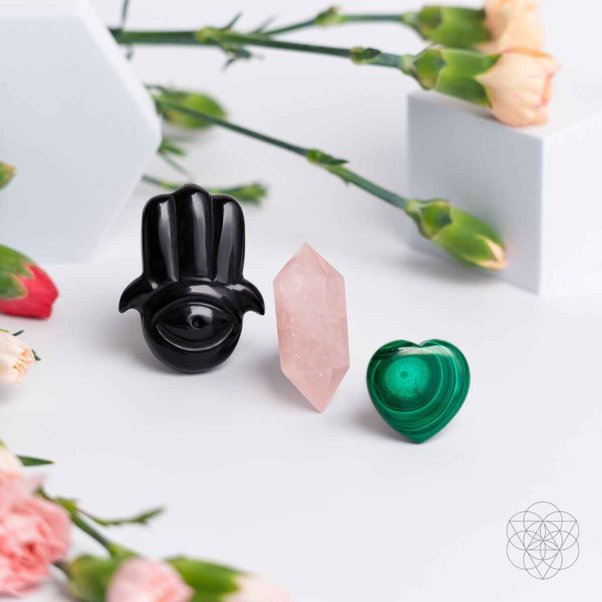 Black hamsa car diffuser with pink rose quartz point and green heart crystal