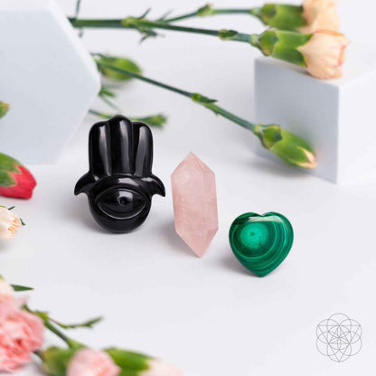 Black hamsa car diffuser with pink rose quartz point and green heart crystal