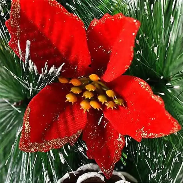Christmas wreath decoration: glittery red poinsettia bloom on snowy pine