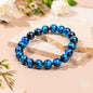 Royal blue beaded bracelet featuring glossy round beads arranged in a circle