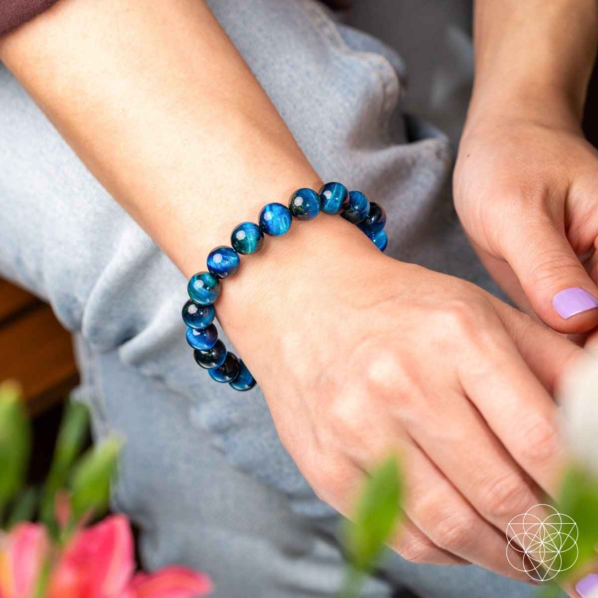 Blue beaded bracelet with round glossy beads on the wrist