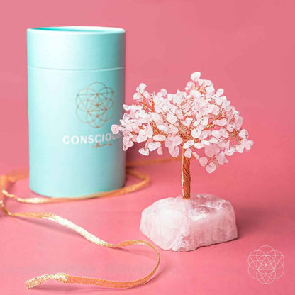 Rose quartz crystal tree with pink blossoms and copper wire trunk on pink stone base