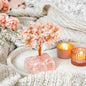 Rose quartz crystal tree with pink blossom branches on a pink stone base