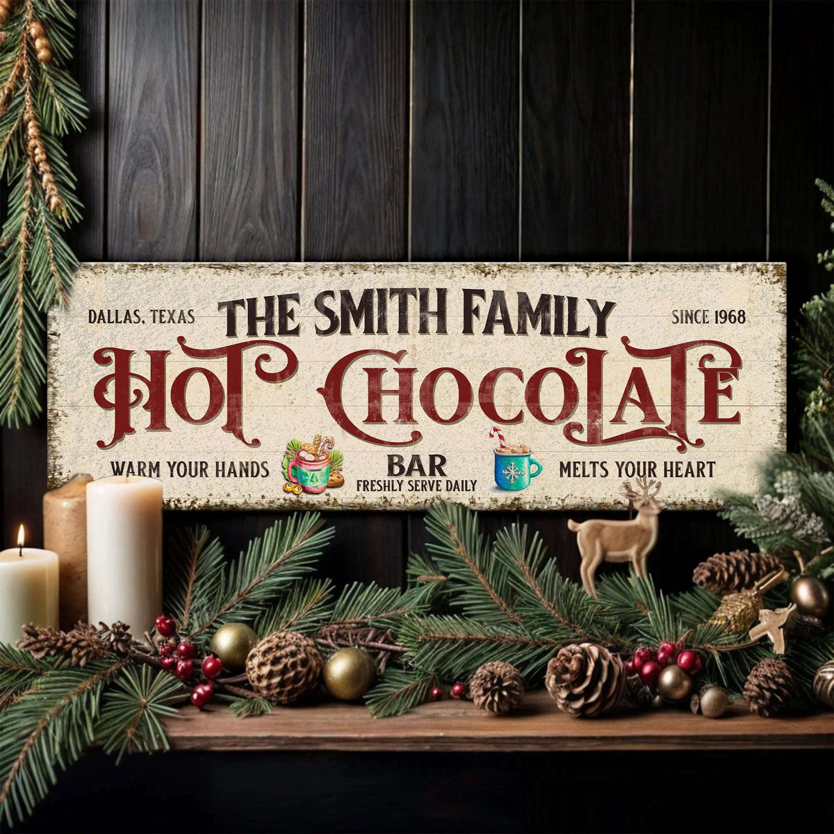 Hot chocolate bar wall sign with winter greenery, candle, and small deer figurine