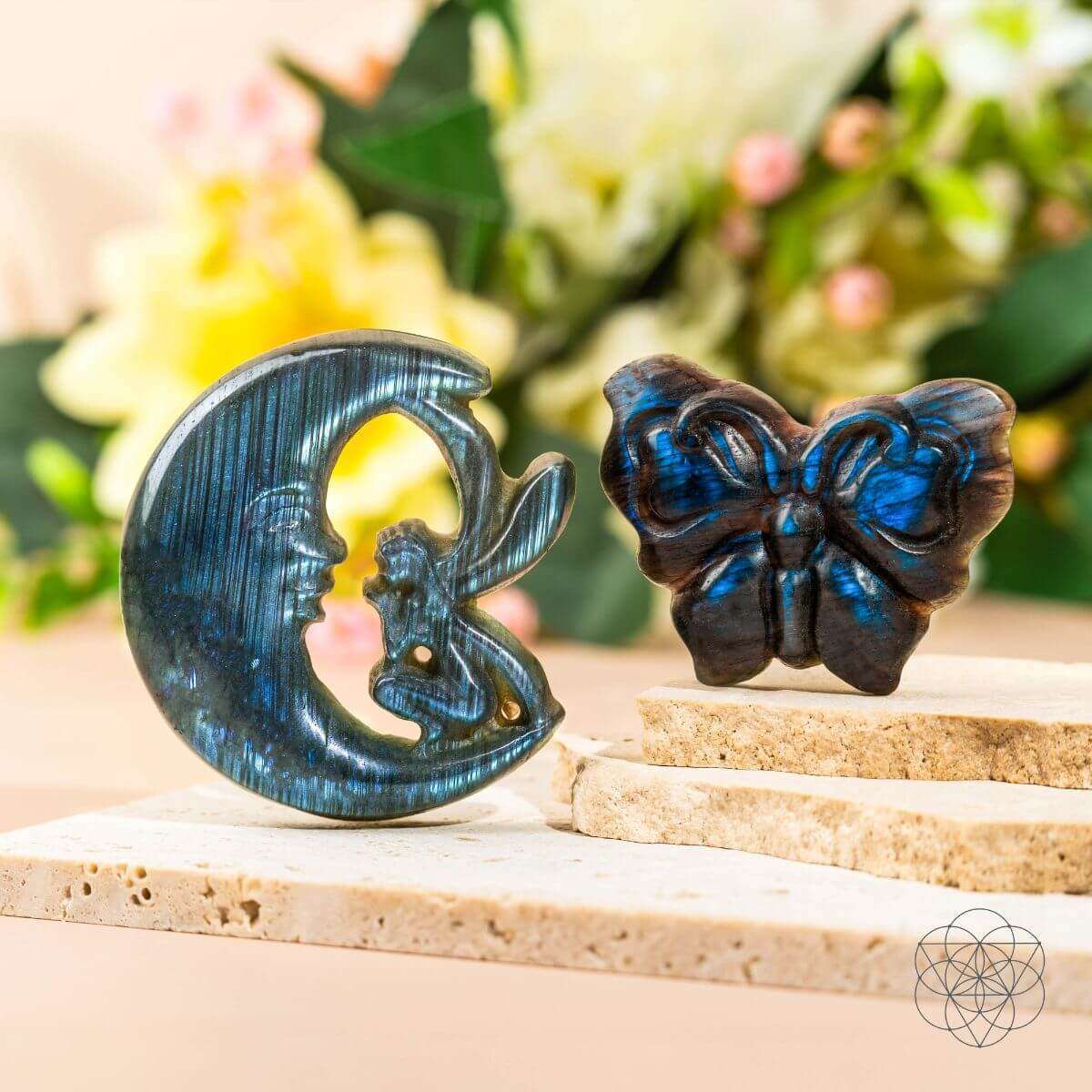 Blue labradorite moon and butterfly carvings on a stone ledge