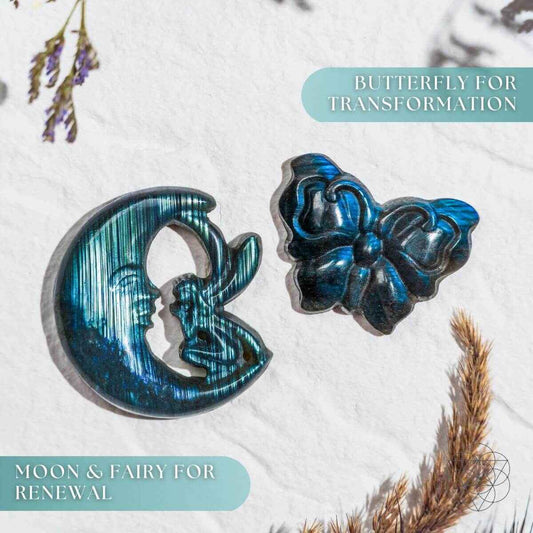 Blue labradorite moon and butterfly carvings on a light fabric surface