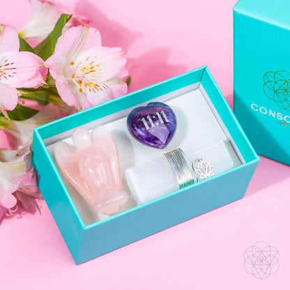 Car crystal kit contents in teal box: rose quartz angel, amethyst heart, metal clip