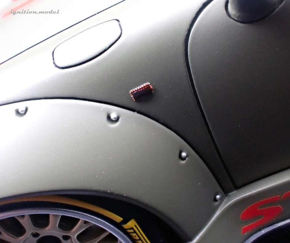 1:18 matte green Porsche model car, fender close-up with side decal