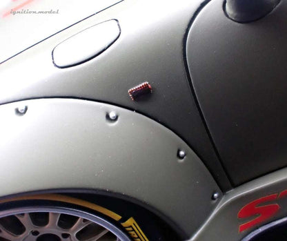 1:18 matte green Porsche model car, fender close-up with side decal