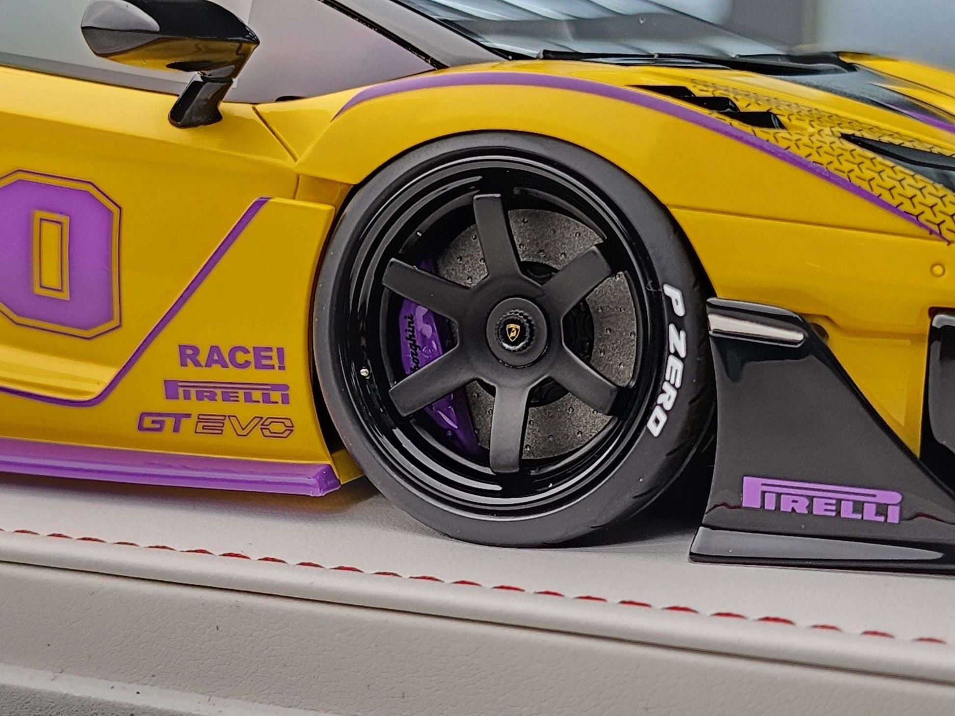 Yellow Lamborghini Aventador GT Evo die-cast model car with front wheel and Pirelli accents