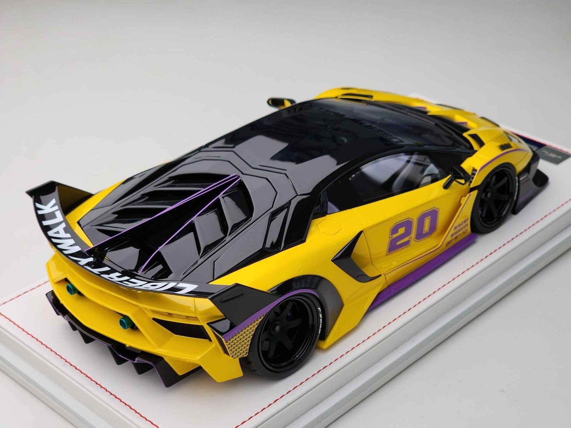 Yellow and black 1:18 Lamborghini-style model car with #20 on white display base
