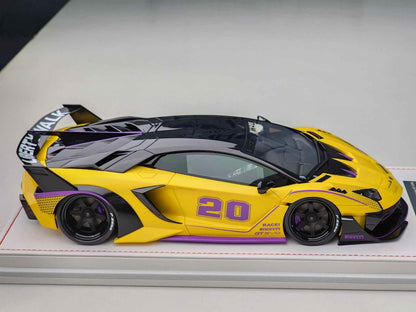 Yellow and black Lamborghini Aventador GT Evo 1:18 model car on display base, front 3/4