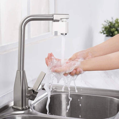 Automatic sensor sink faucet with chrome spout and water stream over stainless basin