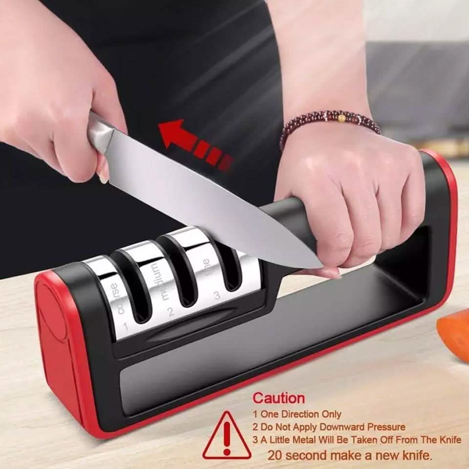 Knife sharpener tool in use with a chef’s knife guided into sharpening slots