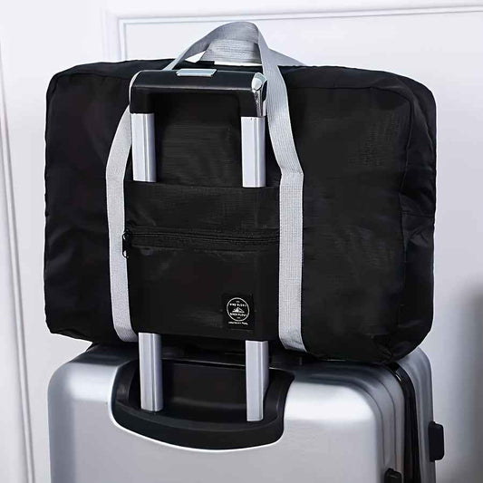 Black nylon duffel bag with front zip pocket and light gray shoulder straps