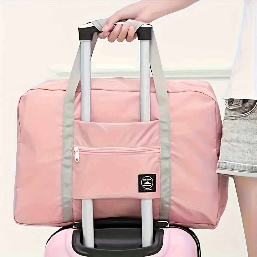 Pink nylon duffel bag on wheeled handle with front zip pocket and gray straps