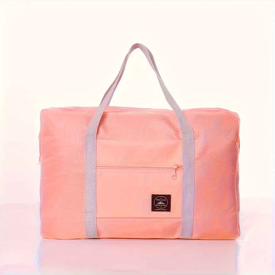 Pink nylon foldable duffel bag with front zip pocket and gray carry handles