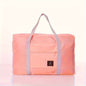 Pink nylon foldable duffel bag with front zip pocket and gray carry handles