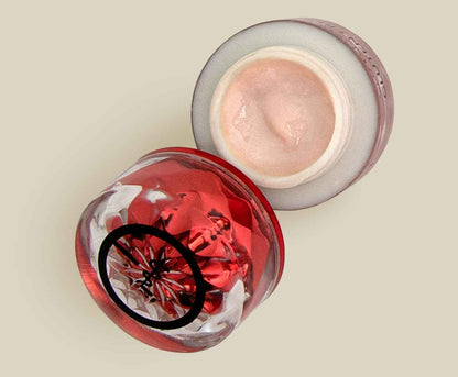 Red and clear eye cream jars with visible cream layer