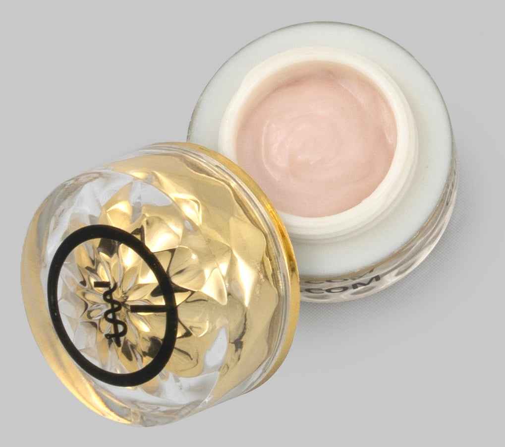 Eye cream jar opened to show pale pink cream inside, with gold-trim lid