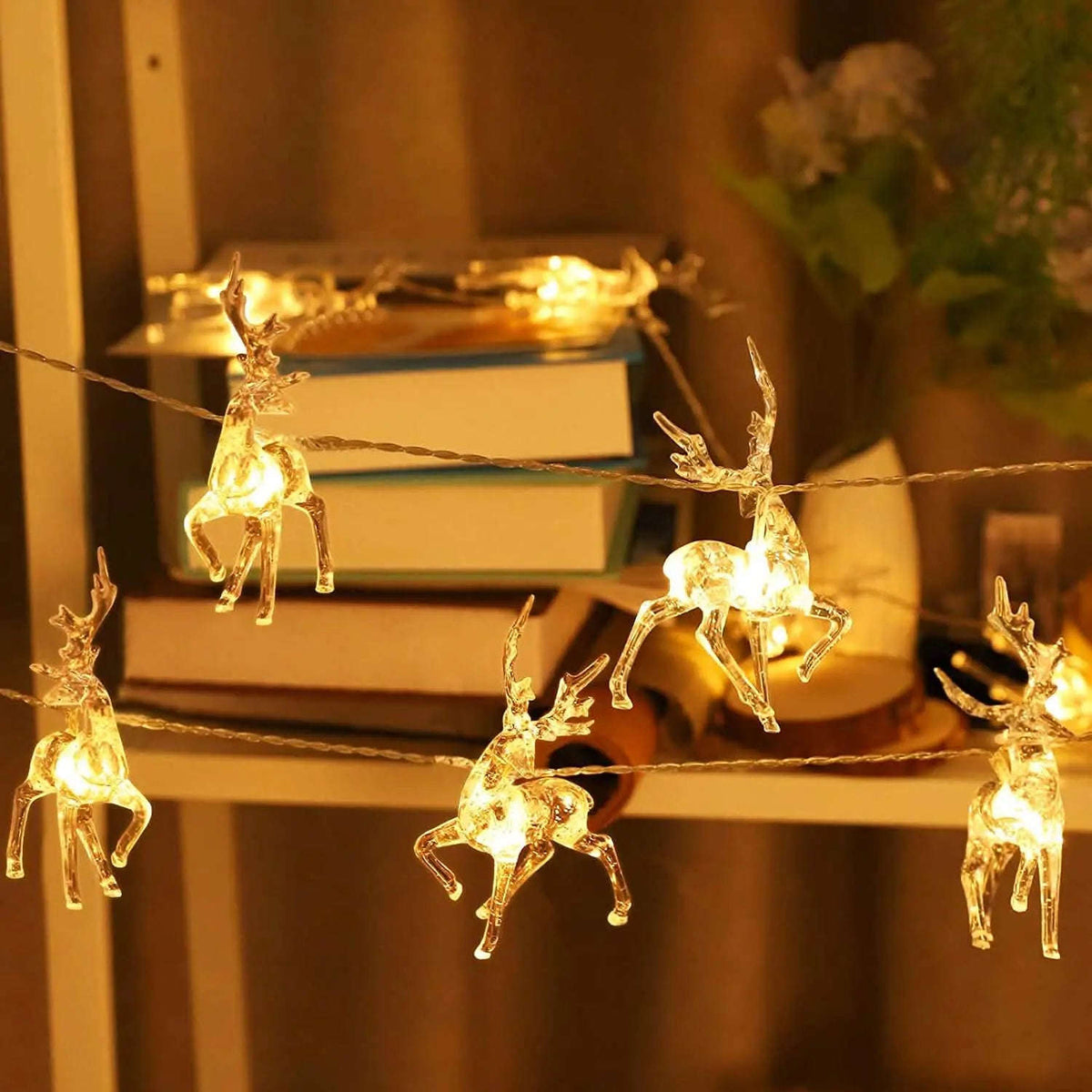 Glowing warm white LED reindeer figures on a light string with twisted wire