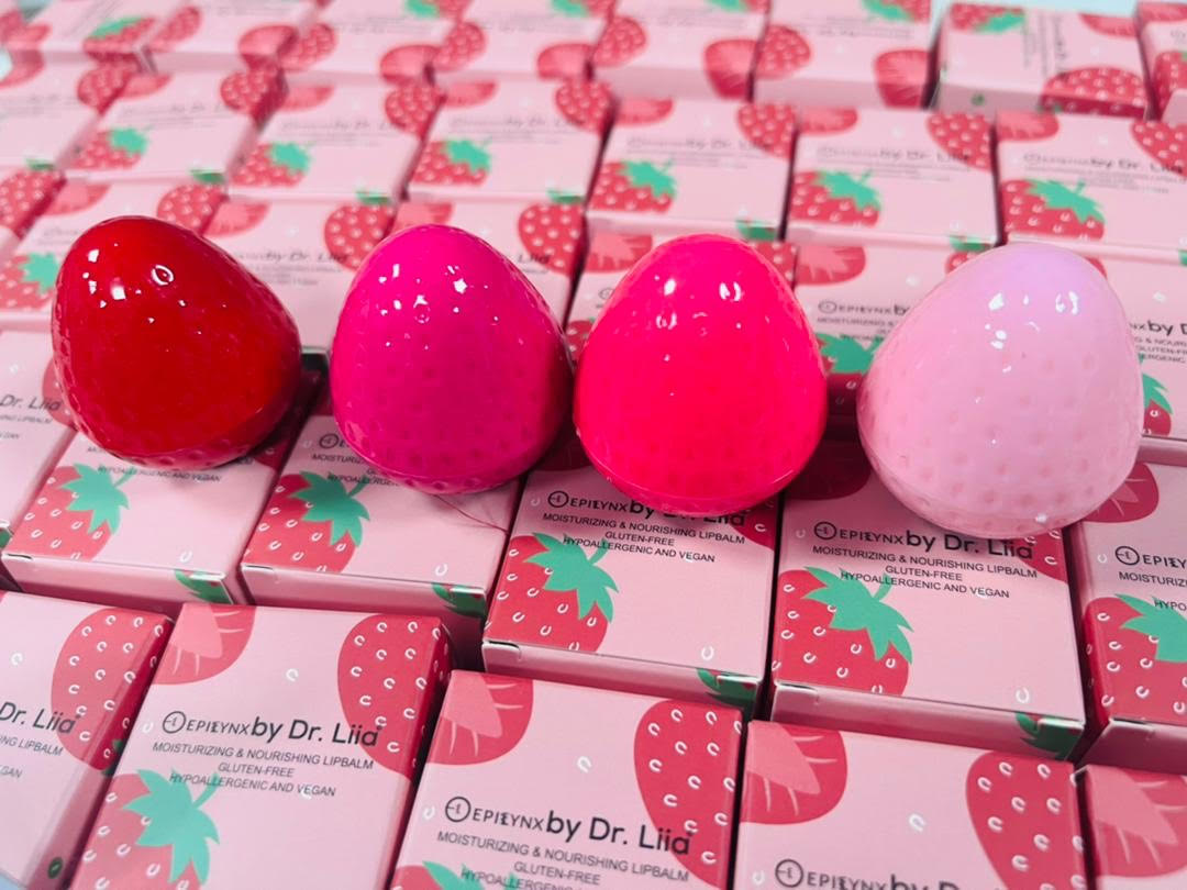 Strawberry-shaped lip butter balm containers in assorted pink and red shades