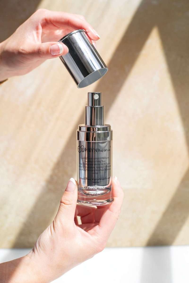 Face moisturizer bottle with pump being dispensed by hands