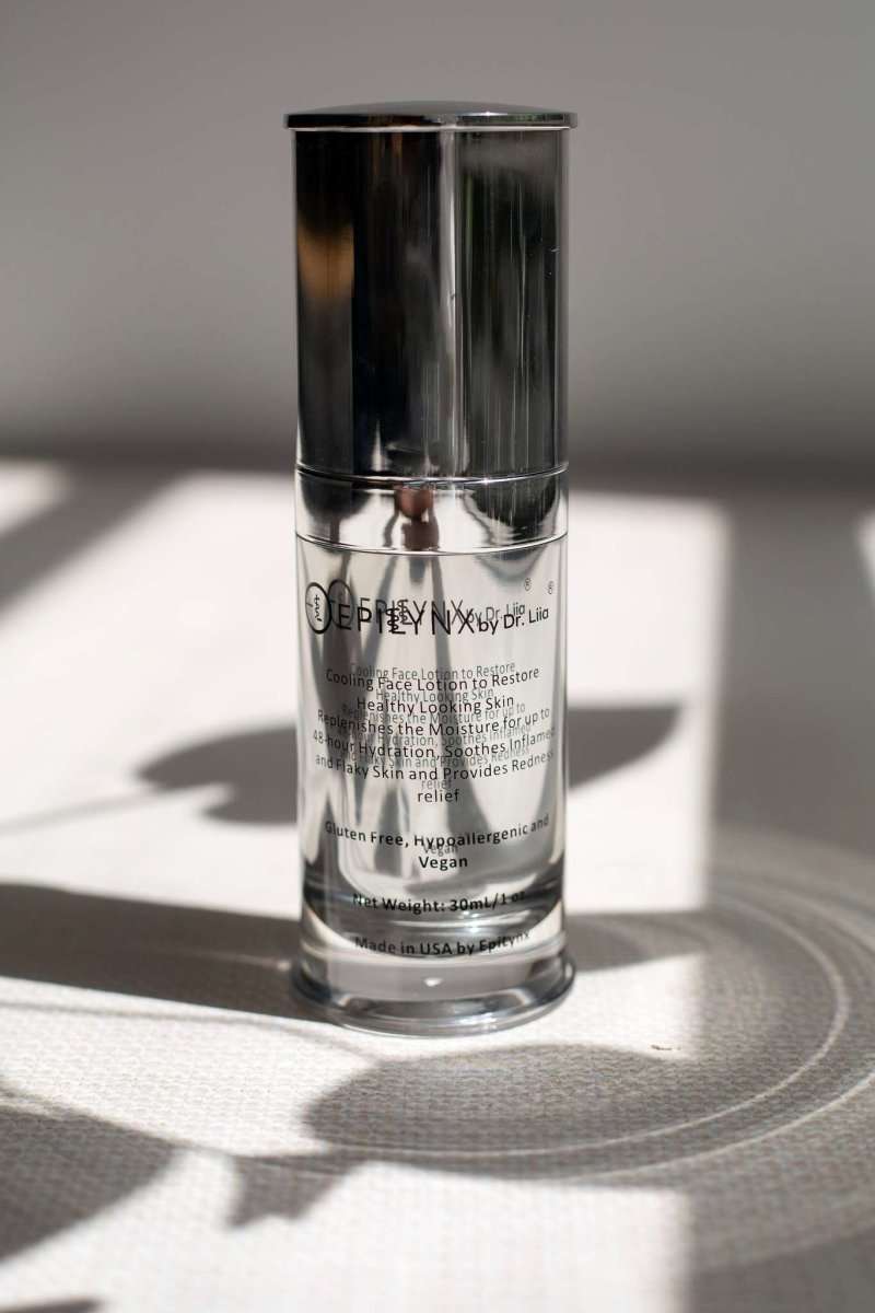Clear and silver face moisturizer bottle with tall cap