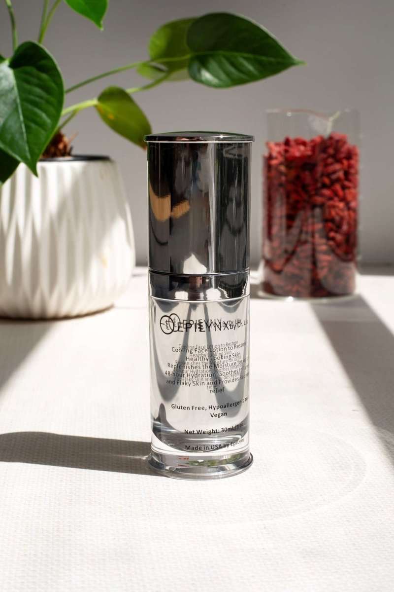 Face moisturizer bottle with silver cap and clear glass container