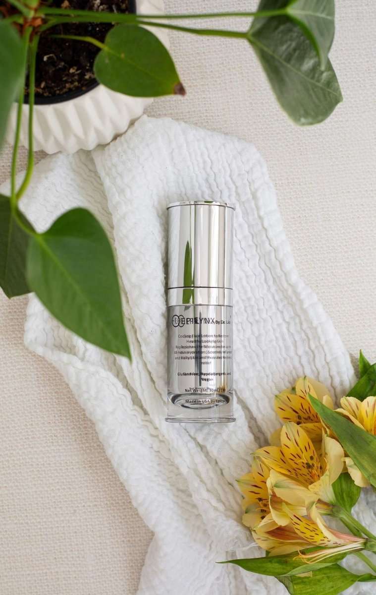 Moisturizer bottle standing on a white towel, silver pump top