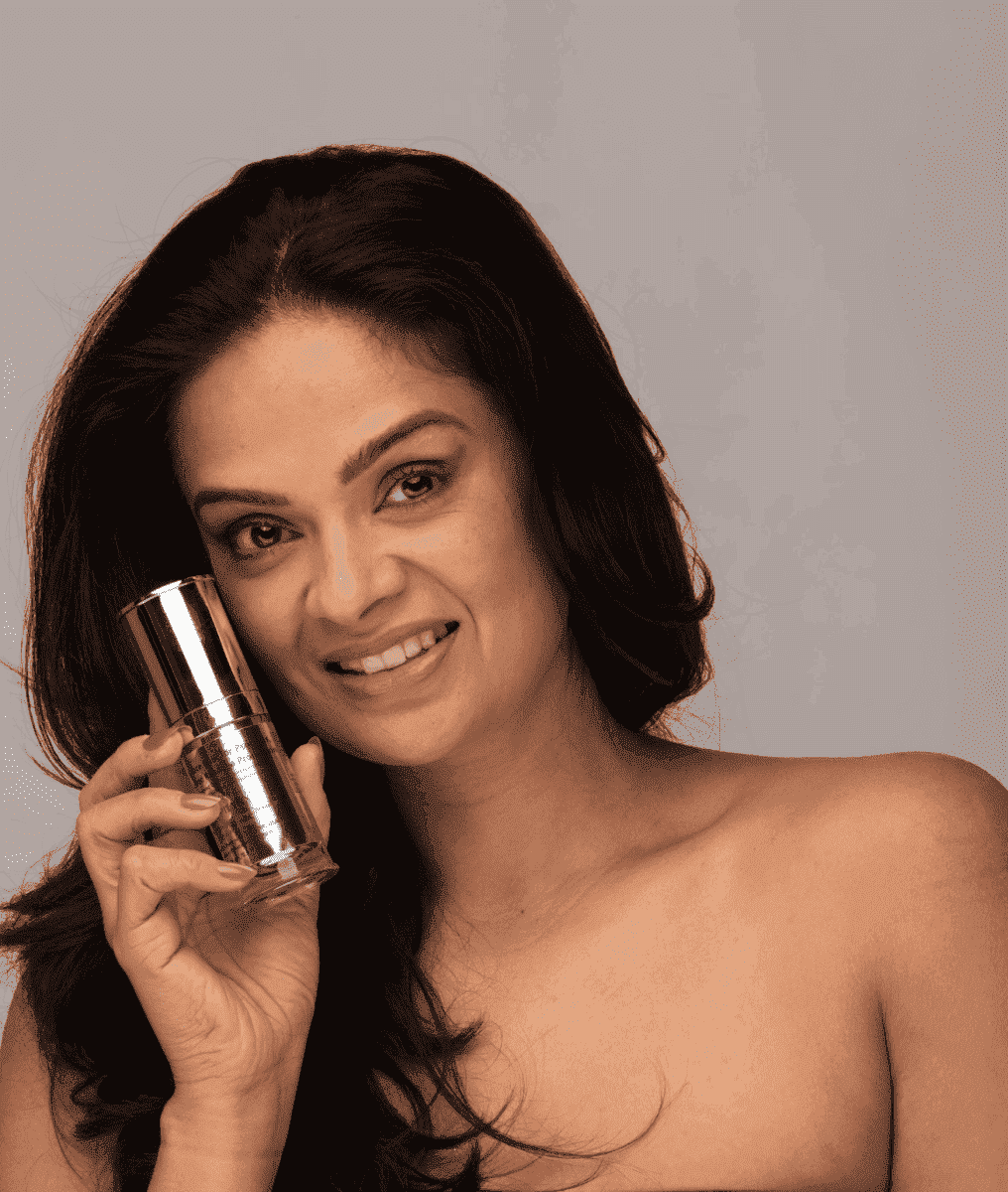 Person holding a silver face moisturizer bottle near the face