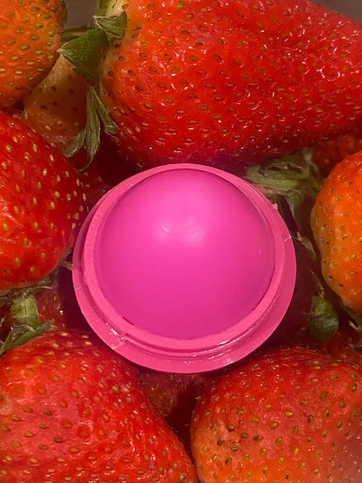 Pink strawberry-shaped lip butter balm pot, open lid