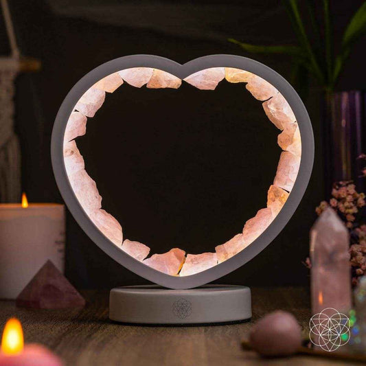 Heart-shaped rose quartz lamp with glowing stone in a gray circular base
