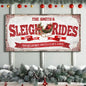 Framed Christmas sign with red Sleigh Rides lettering and Santa Claus Lane banner