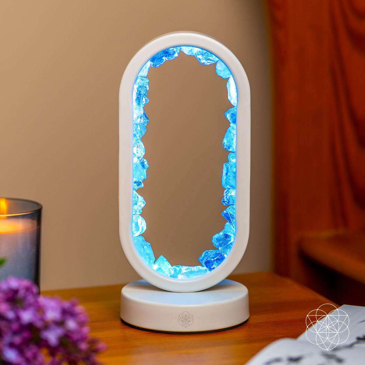 White oval clear quartz lamp with glowing blue crystal border and round base
