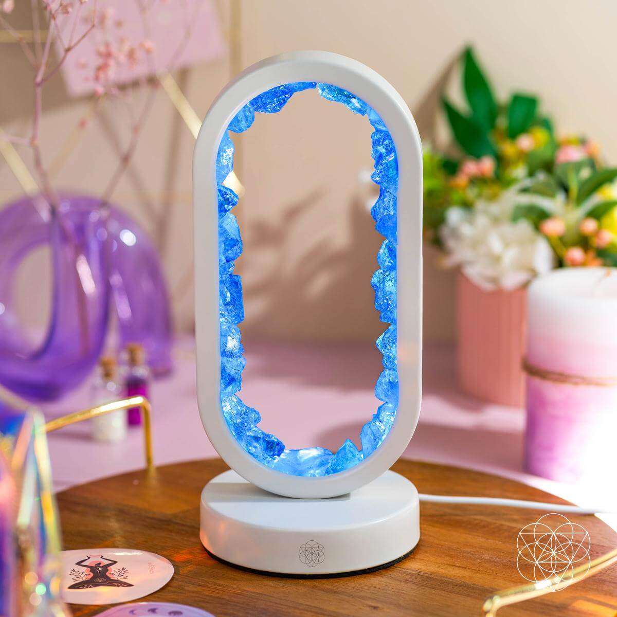 White oval clear quartz lamp with blue crystal border on round base