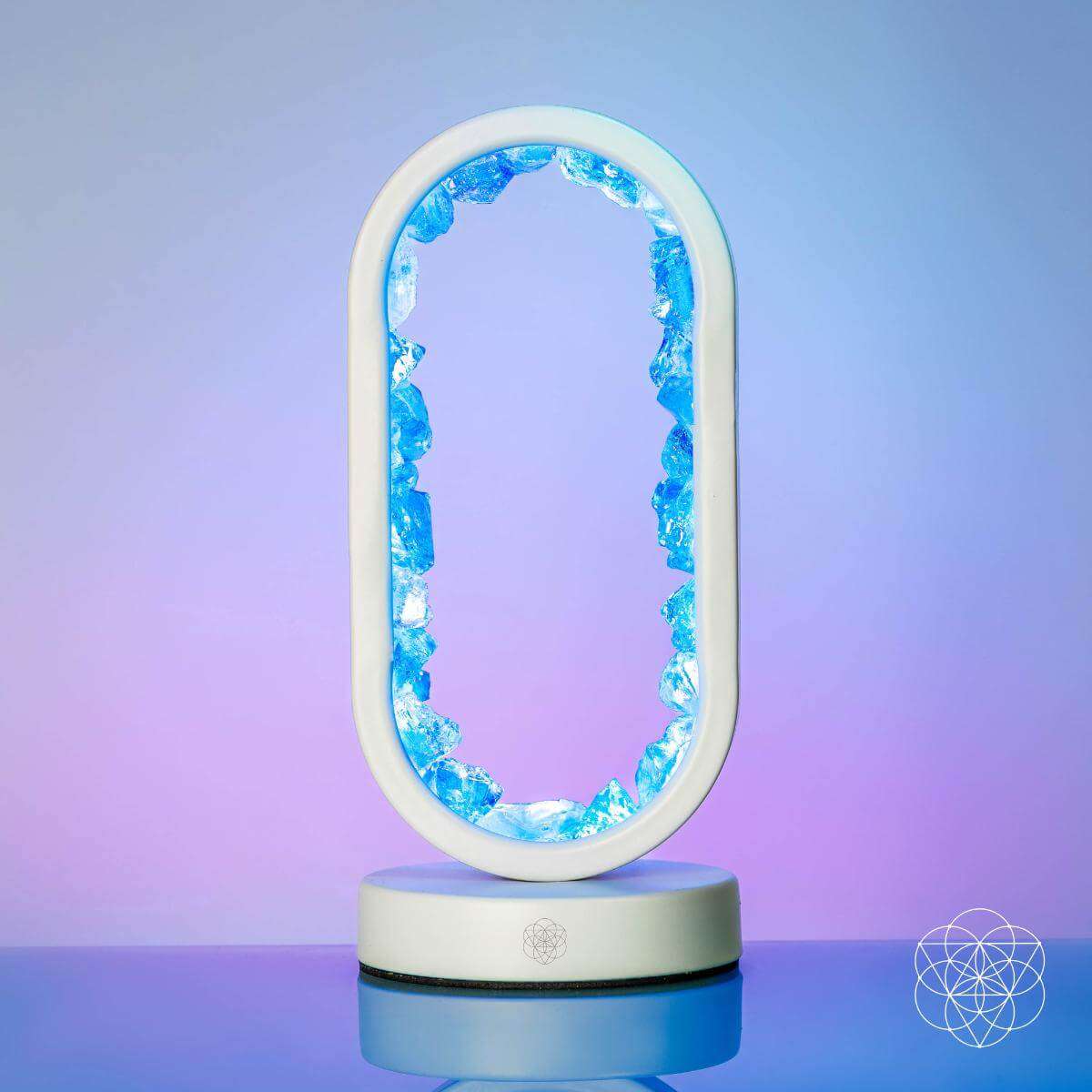 Oval clear quartz lamp with glowing blue crystal edge and light-up base