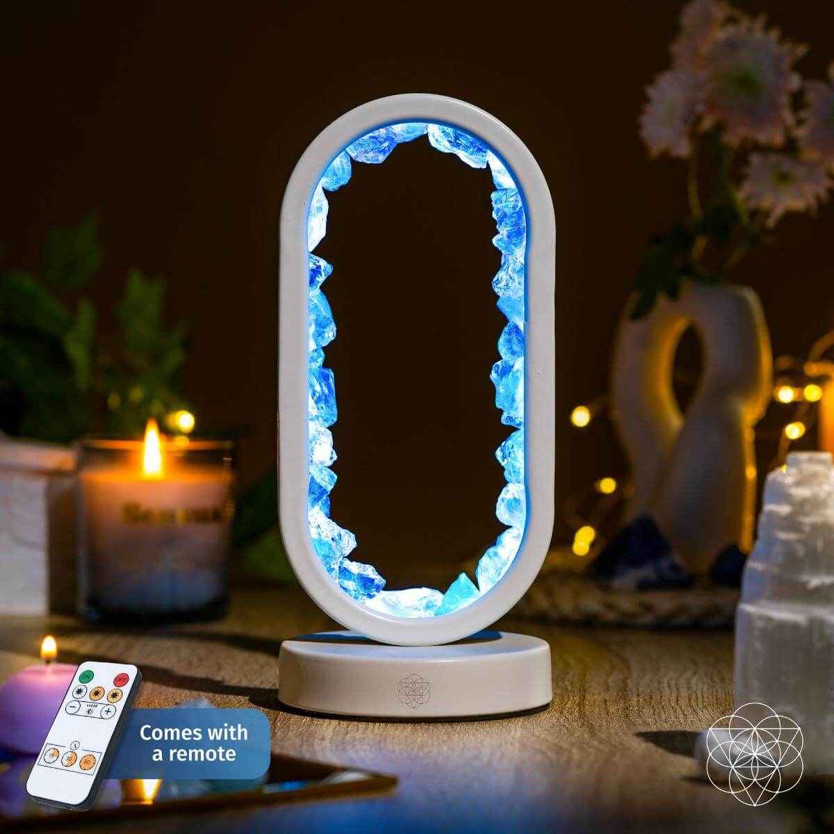Oval clear quartz achievement lamp on white base, blue glow, remote in foreground