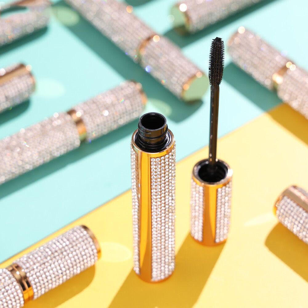 Sparkly rhinestone mascara tube with open cap and black wand