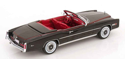 Black convertible model car with red interior, steering wheel visible, white pinstripe detail