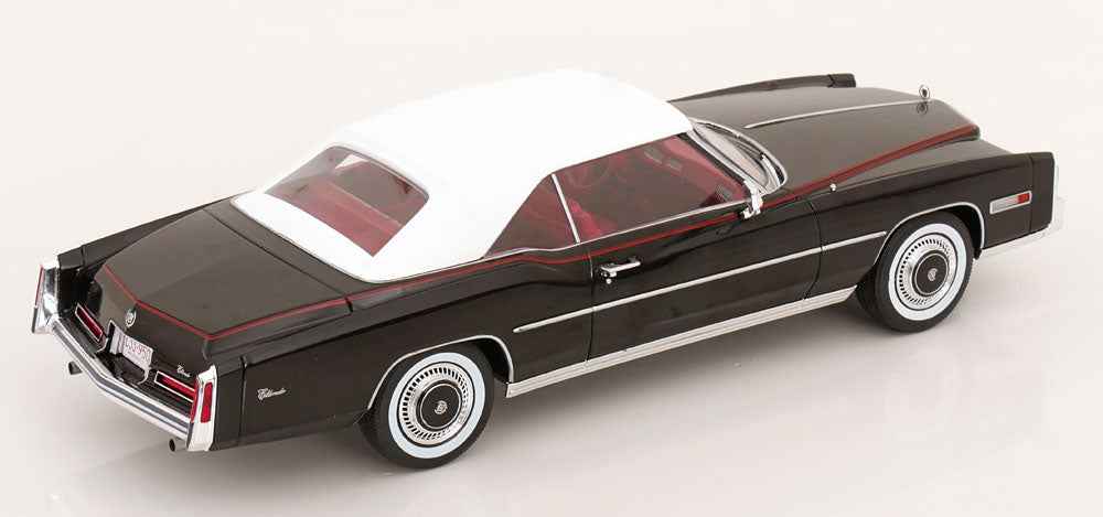 Black convertible model car with red interior, white pinstripe, side view, chrome wheels